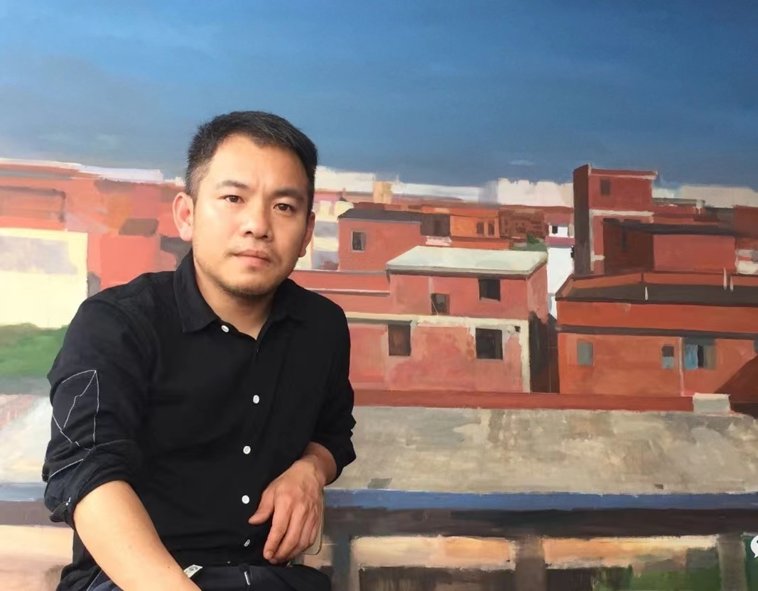吴明亮在自己创作的油画作品前.jpg